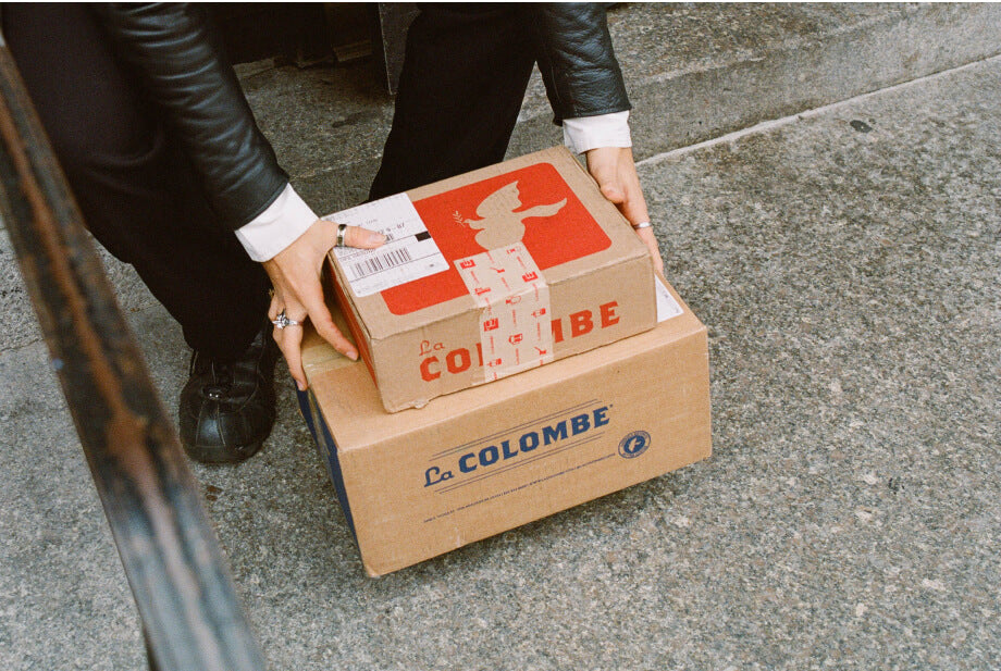 La Colombe delivery boxes being picked up from a stoop.