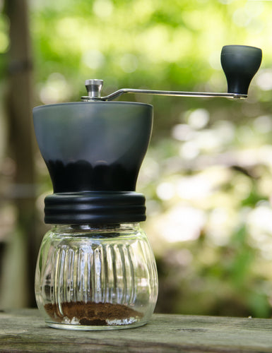 Front shot of a Hario Skerton Plus Coffee Mill outside.