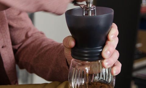 Image of someone using a Hario Skerton Plus Coffee Mill.